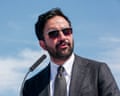 Zohran Mamdani in sunglasses at microphone