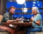 Henry and Lynn chat across a restaurant table