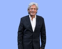 Actor Nigel Havers in black jacket and white shirt against purple background