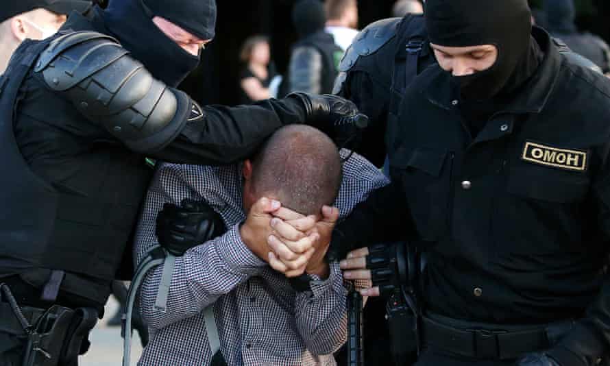 Police officers detain a participant in a protest in Belarus on Monday.