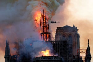 The steeple collapses as smoke and flames engulf the Notre-Dame Cathedral in Paris