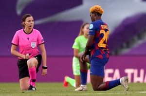 Barcelona’s Asisat Oshoala and match referee Katalin Kulcsar take a knee in support of Black Lives Matter.