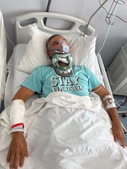 Ljubisa Karović in hospital in Greece wearing an oxygen mask and neck brace