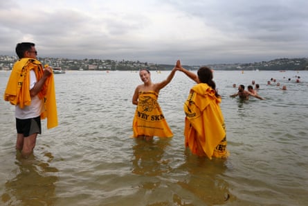 Casey Burgess gives a 'high five' to a volunteer as she takes part in the 'Sydney Skinny' on March 12, 2023 in Sydney, Australia.