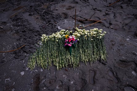 Flowers are placed on mud as a tribute at the disaster-hit area at Gyirong Port.