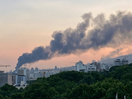 Smoke rises over a city.