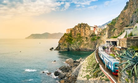 Manarola, Cinque Terre - train station in small village with colourful houses on cliff overlooking sea. Cinque Terre National Park with rugged coastline, Italy.