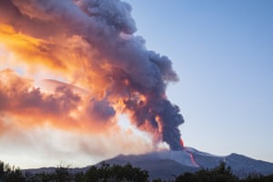 Ash and smoke billow into the sky as lava spews from Mount Etna