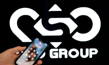 NSO group logo behind a phone