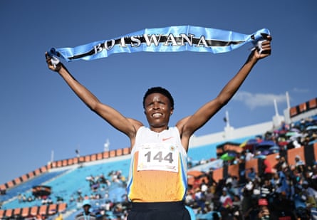 Oratile Nowe raises a Botswana banner above her head