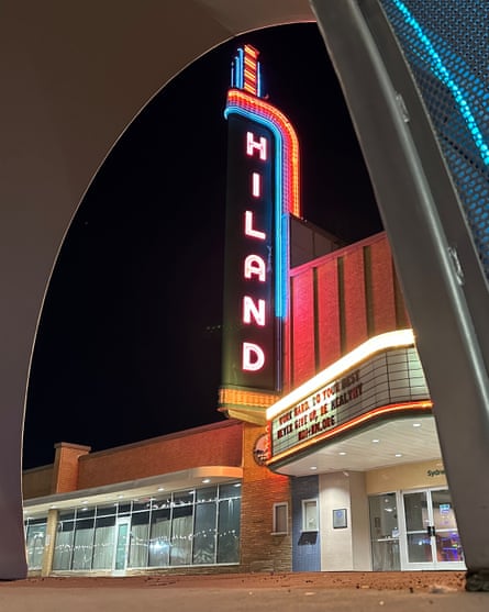 A large neon sign outside the Hiland Theatre