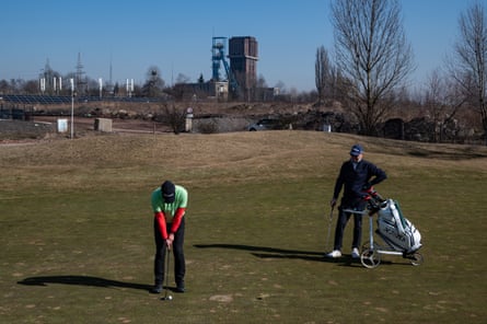 People play golf under a blue sky at Armada golf club in Bytom
