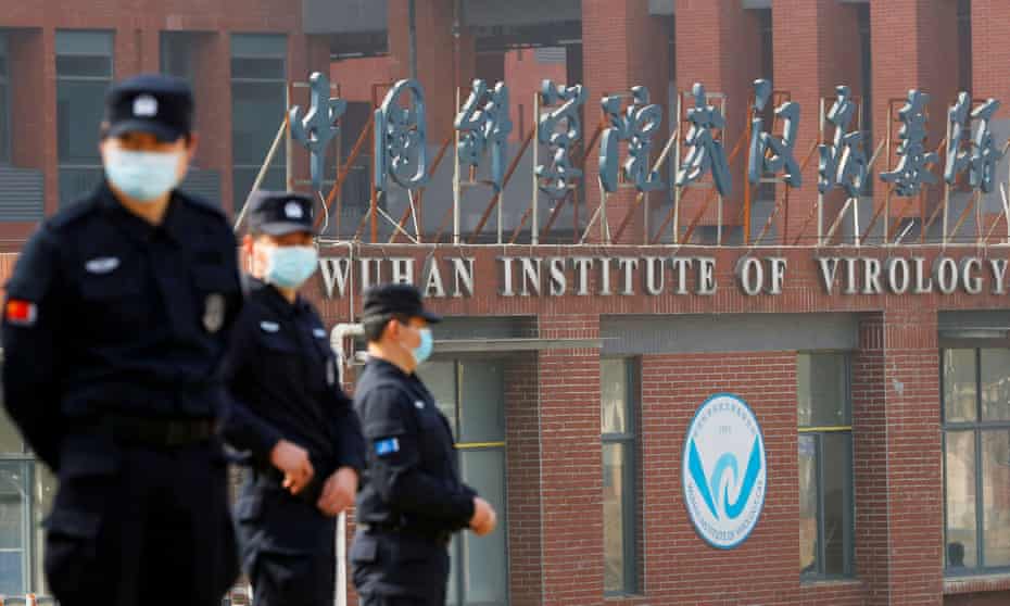 Security personnel keep watch outside the Wuhan Institute of Virology during a visit by WHO investigators on 3 February 2021