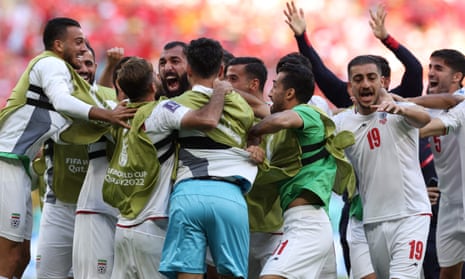 Iran's players celebrate after Roozbeh Cheshmi opened the scoring against Wales.
