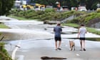 Man found dead in Queensland flood water as weather systems collide over eastern Australia