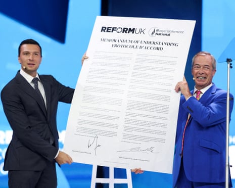 Britain's Reform UK party leader and MP for Clacton, Nigel Farage, and President of the French far-right party Rassemblement National (RN), Jordan Bardella, react after signing a Memorandum of Understanding between the two parties during the Reform UK party conference in Birmingham, Britain.