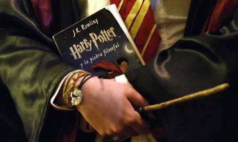a Harry Potter fan arrives with a wand and a Harry Potter book