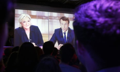 People in Paris watch the TV presidential election debate between Emmanuel Macron and Marine Le Pen on 3 May 2017