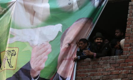 Supporters of Nawaz Sharif watch a campaign rally in Lahore