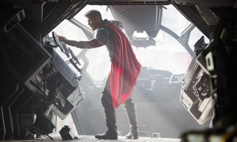 Man in a red cape inside a metal machine