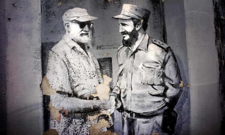 A mural featuring Hemingway shaking hands with Fidel Castro decorates a wall in a car park in Havana.