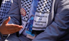 Closeup of chest of man in suit, with keffiyeh that says Democrats for Palestinian Rights.