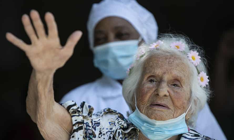 Zelia de Carvalho Morley, 106, waves after receiving a shot of China’s Sinovac CoronaVac vaccine for the new coronavirus at the retirement home where she lives in Rio de Janeiro, Brazil.