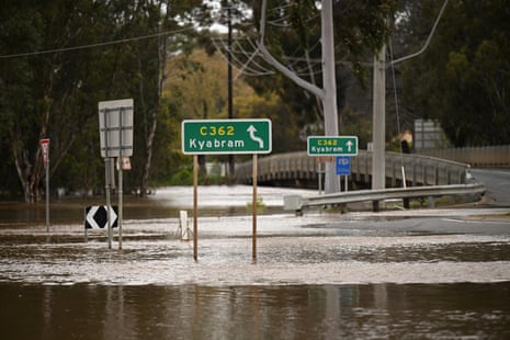 Flood water is seen near a sign for Kyabram in Rochester, Victoria on Friday.