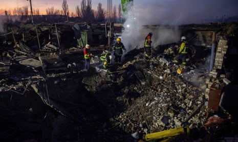 Rescuers work at an area in Mykolaiv, Ukraine, heavily damaged during the wave of Russian missile strikes on New Year’s Eve