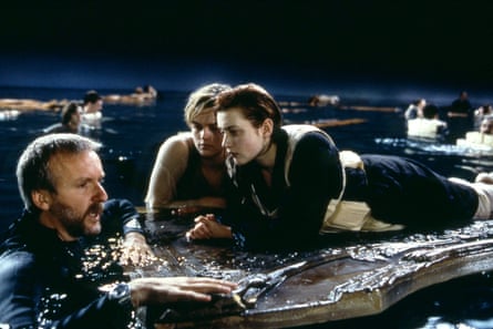 Cameron with Kate Winslet and Leonardo DiCaprio on the set of Titanic.