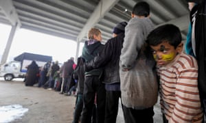 A Syrian boy queues for food at a shelter in the government-controlled Jibreen area of Aleppo.