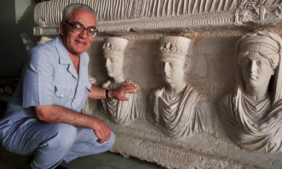 A 2002 picture of Khaled al-Asaad in front of a rare sarcophagus from Palmyra depicting two priests dating from the first century.