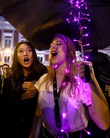 Women protest in the rain at the Puerta del Sol square in Madrid.