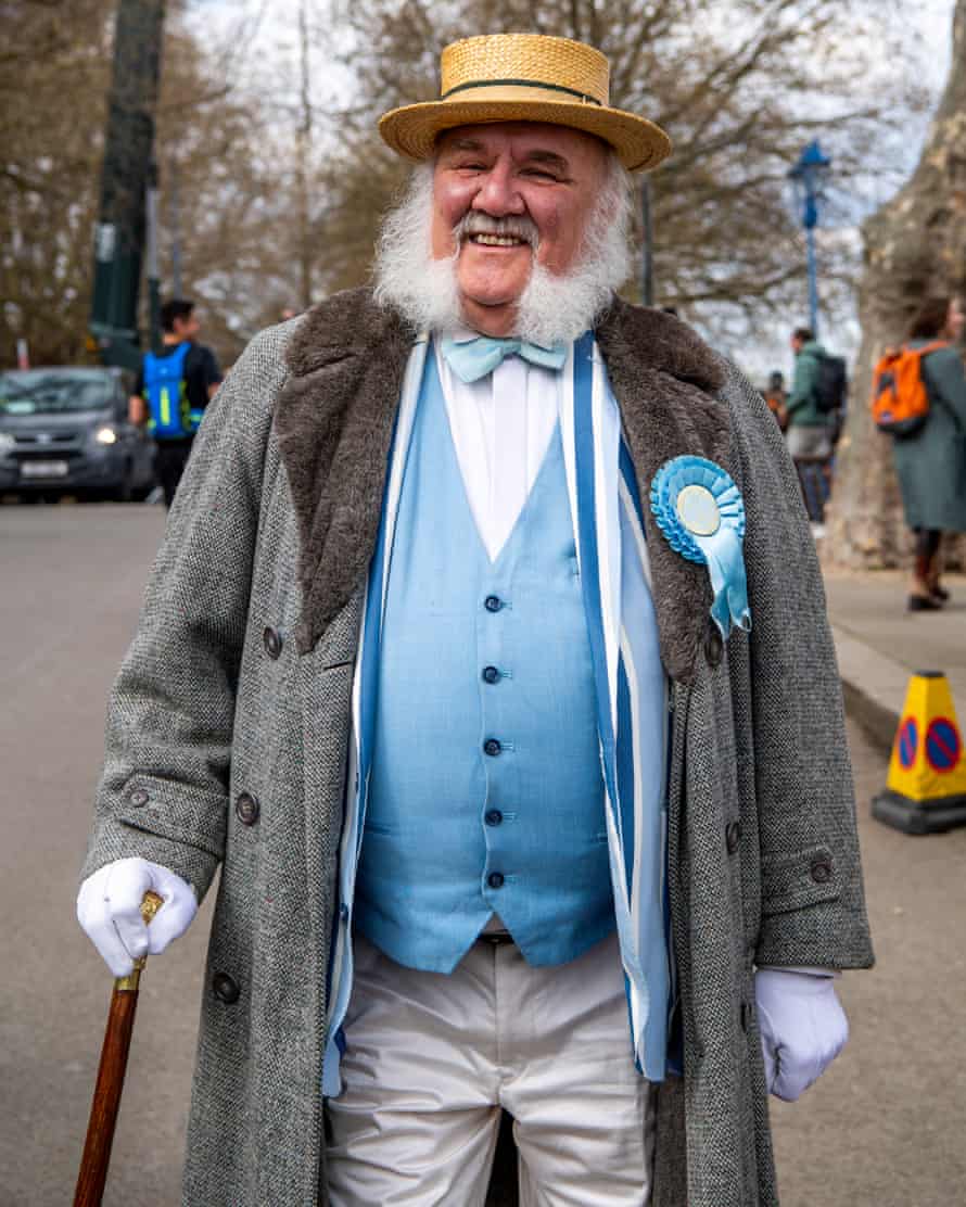 Whiskered gentleman in longcoat and boater