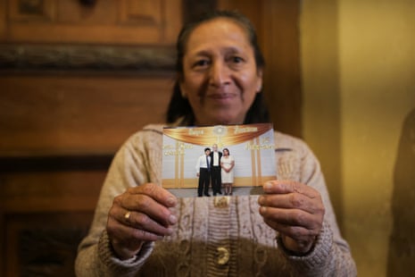 A woman hold up a picture taken with Robert Prevost, now Pope Leo XIV.