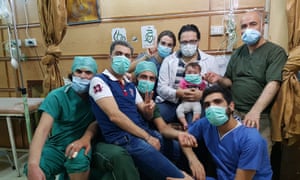 Hamza al-Kateab (centre) holding baby Sama in For Sama.