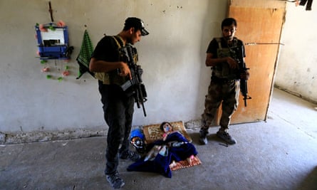 Iraqi forces inspect a house in west Mosul on Thursday.