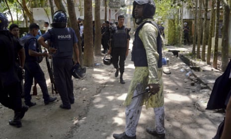 Bangladeshi policemen arrive near the scene of the attack in Sholakia