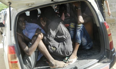 Garissa University students take shelter in a vehicle after fleeing al-Shabaab’s latest attack