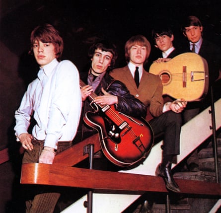 The Rolling Stones standing on a staircase