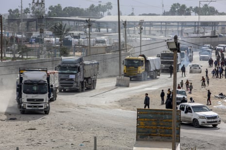 Trucks carrying medicine and humanitarian aid enter through the Karm Abu Salem commercial crossing.