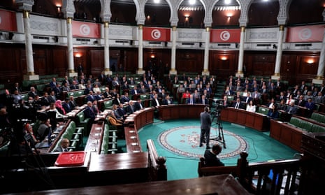 MPs sit in chamber during first meeting of the new Tunisian parliament.