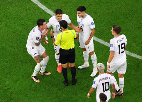 Uruguay's Maxi Gomez, Luis Suarez and Jose Maria Gimenez remonstrate with referee Alireza Faghani after he gave Portugal that penalty.