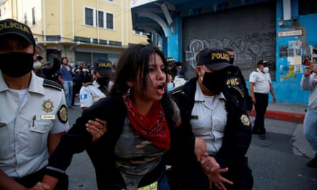 A demonstrator is arrested during clashes between the police and protesters in Guatemala City on Saturday.