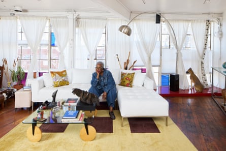 a woman sits on a couch in a living room