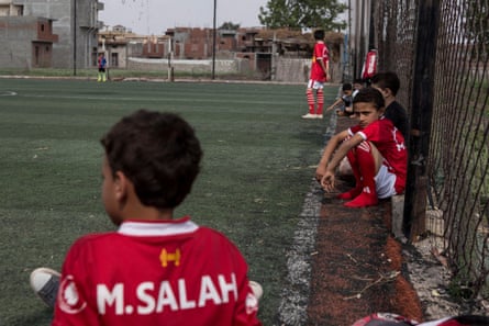 Egyptian boys wearing T-shirts bearing the name of Mohamed Salah wait for their turns to take part in training session in Nagrig.
