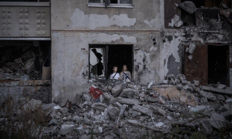 Two young children inside a damage building following a Russian attack in the Staryi Saltiv town of Kharkiv, Ukraine.