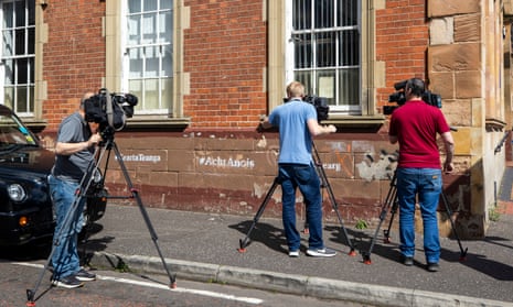 Camera crews capture footage of part of a leaked document that appeared on a wall in Belfast