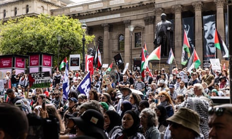 Protesters hold banners and flags as they march towards the Victorian Parliament during a Pro-Palestine demonstration in Melbourne, Australia, 03 December 2023.