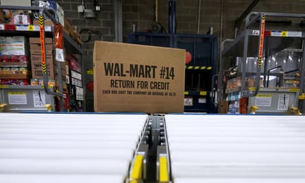 A box of merchandise is unloaded from a truck and sent along a conveyor belt at a Walmart Supercenter in Houston.